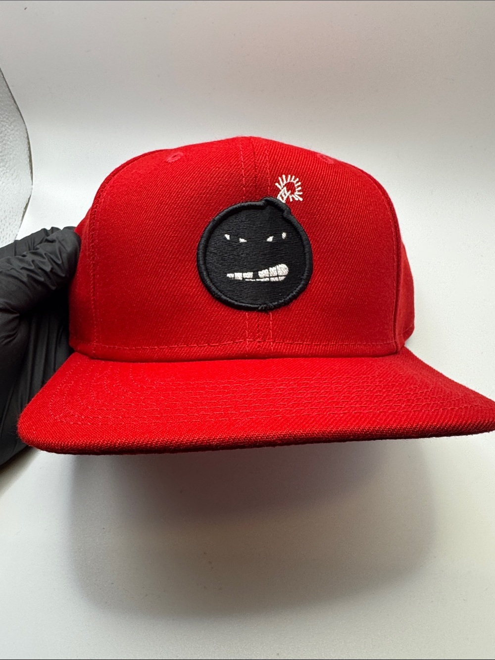 New Era “BOMBFACE” Red Snapback Hat with Black Bomb Patch and White Fuse Detail